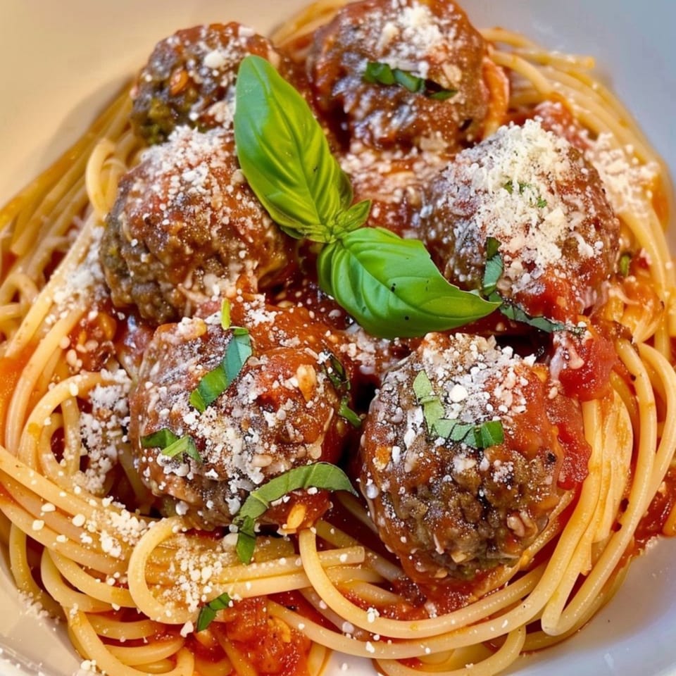 Spaghetti and meatballs with tomato sauce, parmesan cheese, and fresh basil from Amore Pizza & Subs.